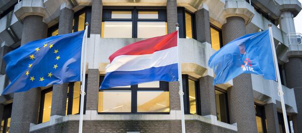 In front of the Dutch ministry of Foreign Affairs: the flag of the European Union, the flag of the Netherlands and a flag with the logo of the Dutch EU presidency In front of the Dutch ministry of Foreign Affairs: the flag of the European Union, the flag of the Netherlands and a flag with the logo of the Dutch EU presidency - Sputnik International