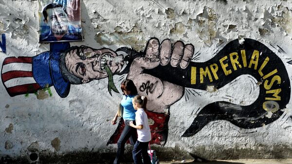 A woman and a girl walk in front of a graffiti of US Uncle Sam in Caracas on March 11, 2015 - Sputnik International