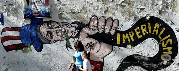 A woman and a girl walk in front of a graffiti of US Uncle Sam in Caracas on March 11, 2015 A woman and a girl walk in front of a graffiti of US Uncle Sam in Caracas on March 11, 2015 - Sputnik International