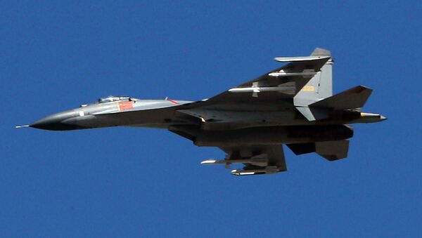 The latest Chinese Jian-series fighter jet executes a fly-by over Beijing on September 12, 2009 during a rehearsal for National Day - Sputnik International