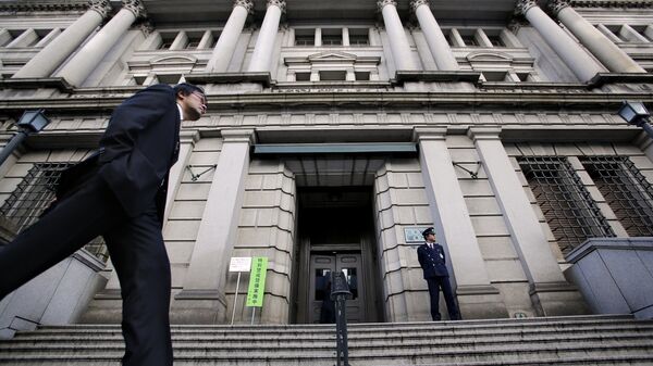In this Nov. 19, 2014 file photo, a man walks by the Bank of Japan headquarters in Tokyo - Sputnik International