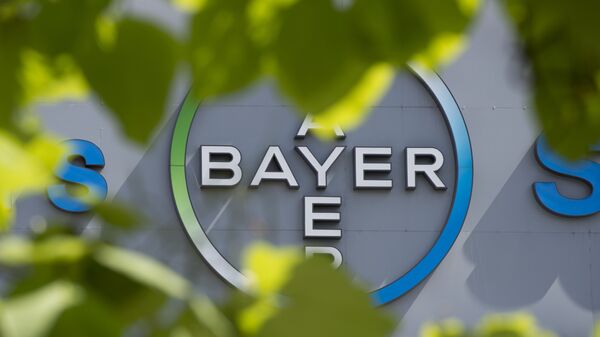 This file photo taken on July 24, 2013 shows a logo of German pharmaceuticals and chemicals giant Bayer on an overpass at its Berlin headquarters - Sputnik International