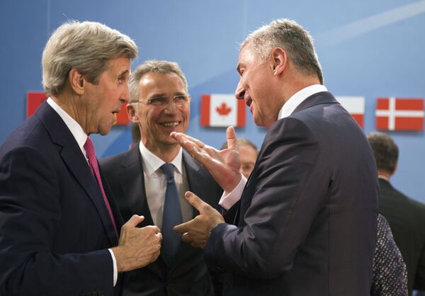 Montenegro's Prime Minister Milo Dukanovic, right, speaks with U.S. Secretary of State John Kerry, left, and NATO Secretary General Jens Stoltenberg, center, during a meeting of the North Atlantic Council at NATO headquarters in Brussels on Thursday, May 19, 2016 Montenegro's Prime Minister Milo Dukanovic, right, speaks with U.S. Secretary of State John Kerry, left, and NATO Secretary General Jens Stoltenberg, center, during a meeting of the North Atlantic Council at NATO headquarters in Brussels on Thursday, May 19, 2016 - Sputnik International