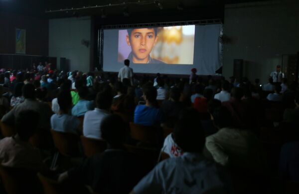 Palestinian families attending the screening of a movie during the opening of the Red Carpet cinema festival in Gaza City, on May 12, 2016. Palestinian families attending the screening of a movie during the opening of the Red Carpet cinema festival in Gaza City, on May 12, 2016. - Sputnik International