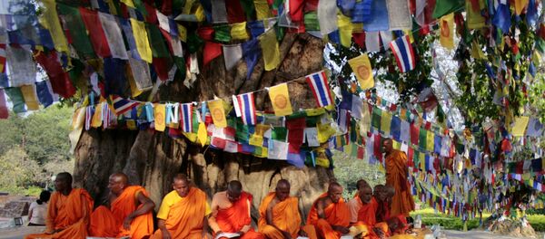 Monks chant as they sit under the Bodhi tree adjacent to the Maya Devi Temple in Lumbini. (File) Monks chant as they sit under the Bodhi tree adjacent to the Maya Devi Temple in Lumbini. (File) - Sputnik International