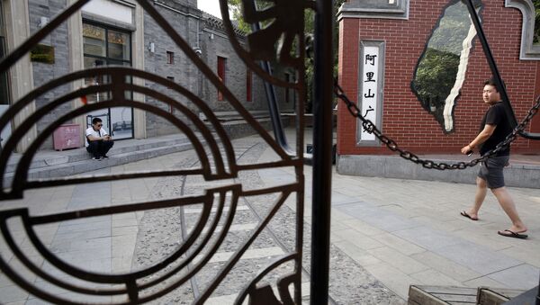 A man walks past a little used Taiwan themed retail district with an outline of the Taiwan island in Beijing Friday - Sputnik International