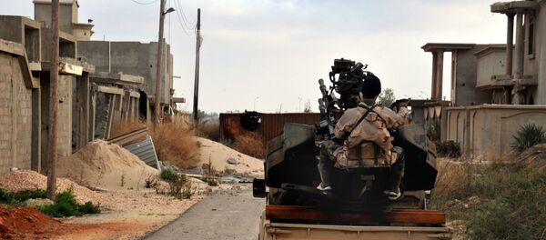 Man loyal to the Libyan armed forces prepares himself for clashes with Islamic State group militants in Libya. (File) - Sputnik International
