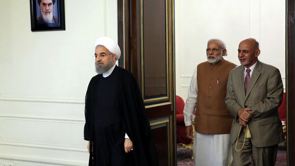 Afghanistan President Ashraf Ghani, right, Indian Prime Minister Narendra Modi, center, and Iranian President Hassan Rouhani, left, arrive to attend their trilateral meeting at the Saadabad Palace in Tehran, Iran, Monday, May 23, 2016. - Sputnik International