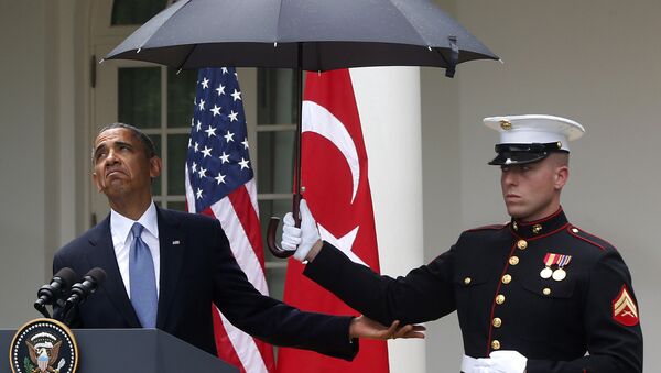 President Barack Obama looks to see if it is still raining as a Marine holds an umbrella for him during his joint news conference with Turkish President Tayyip Erdogan (File) - Sputnik International