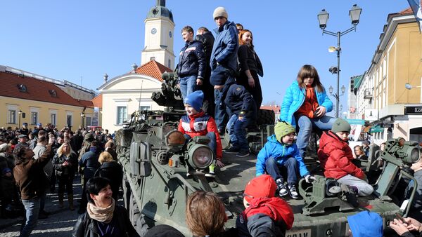 People surround a group of US Army Stryker armored vehicles from the 3rd Squadron of the 2nd Cavalry Regiment, during a stop on the Kosciuszko Market Square to meet residents, in Bialystok, Poland (File) - Sputnik International