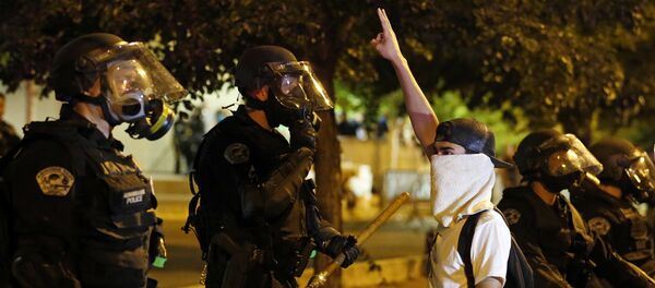 Riot police block off the Albuquerque Convention Center to anti-Trump protests following a rally and speech by Republican presidential candidate Donald Trump at the convention center where the event was held, in Albuquerque, N.M., Tuesday, May 24, 2016 Riot police block off the Albuquerque Convention Center to anti-Trump protests following a rally and speech by Republican presidential candidate Donald Trump at the convention center where the event was held, in Albuquerque, N.M., Tuesday, May 24, 2016 - Sputnik International