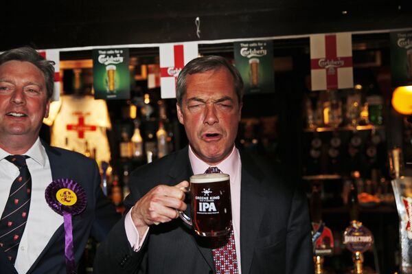 In this Friday, May 23, 2014 file photo, Nigel Farage, leader of Britain's United Kingdom Independence Party (UKIP) enjoys a pint of beer in South Benfleet, England.  - Sputnik International