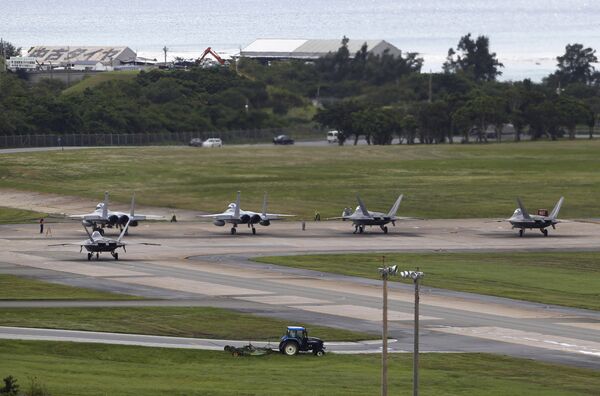  U.S. Air Force F-22 Raptors, right, and two F-15 Eagles prepare for take-off at Kadena Air Base on the southern island of Okinawa, in Japan (File) - Sputnik International