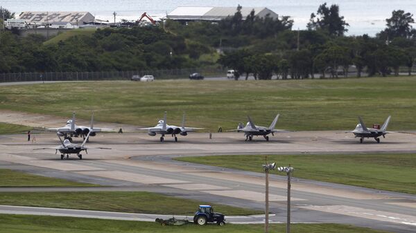 U.S. Air Force F-22 Raptors, right, and two F-15 Eagles prepare for take-off at Kadena Air Base on the southern island of Okinawa, in Japan (File) - Sputnik International