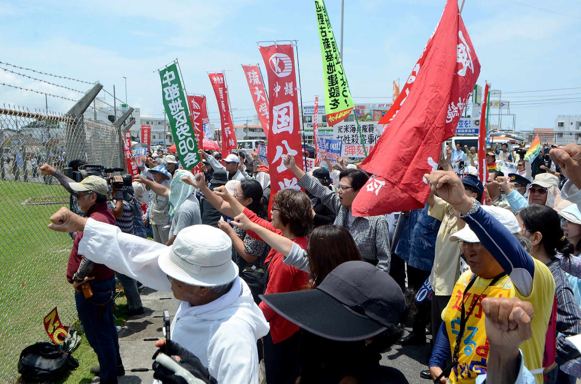 People raise their fists as they shout slogans to protest against the US military presence in front of the US Kadena Air Base in Cyatan, Okinawa prefecture, on May 21, 2016 - Sputnik International, 1920, 31.07.2024