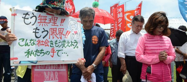 People offer a silent prayer in front of the US Kadena Air Base in Cyatan, Okinawa prefecture, to protest against the US military presence in Okinawa on May 21, 2016 People offer a silent prayer in front of the US Kadena Air Base in Cyatan, Okinawa prefecture, to protest against the US military presence in Okinawa on May 21, 2016 - Sputnik International