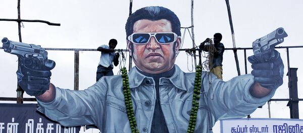 Fans tie a sweet lemon garland onto a cut out of Tamil film actor Rajinikanth on the release of his latest film Endhiran (Robot) in Chennai on October 1, 2010 Fans tie a sweet lemon garland onto a cut out of Tamil film actor Rajinikanth on the release of his latest film Endhiran (Robot) in Chennai on October 1, 2010 - Sputnik International