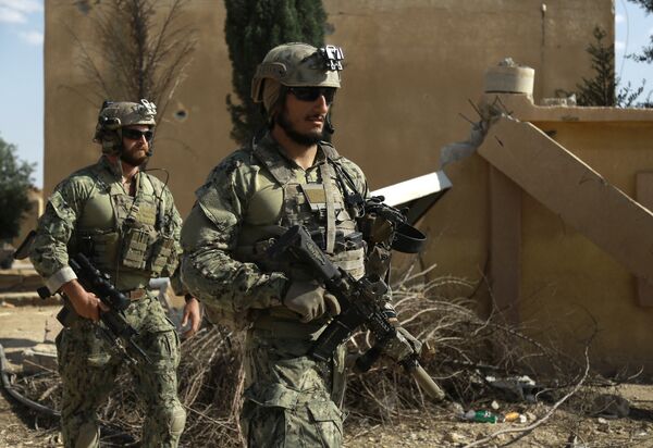 Armed men in uniform identified by Syrian Democratic forces as US special operations forces walk in the village of Fatisah in the northern Syrian province of Raqa on May 25, 2016 Armed men in uniform identified by Syrian Democratic forces as US special operations forces walk in the village of Fatisah in the northern Syrian province of Raqa on May 25, 2016 - Sputnik International