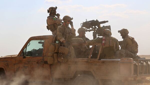 Armed men in uniform identified by Syrian Democratic forces as US special operations forces ride in the back of a pickup truck in the village of Fatisah in the northern Syrian province of Raqa on May 25, 2016 - Sputnik International