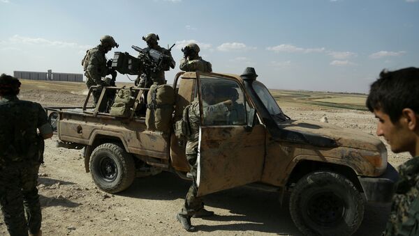 Armed men in uniforms identified by Syrian Democratic forces as US special operations forces stand in the back of a pickup truck in the village of Fatisah in the northern Syrian province of Raqa on May 25, 2016 - Sputnik International