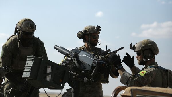 Men in uniform identified by Syrian Democratic forces as US special operations forces as they ride in the back of a pickup truck in the village of Fatisah in the northern Syrian province of Raqa. (File) - Sputnik International