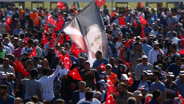 A man waves a flag with the image of Turkish President Tayyip Erdogan during a rally to mark the 563rd anniversary of the conquest of the city by Ottoman Turks, in Istanbul, Turkey, May 29, 2016. - Sputnik International