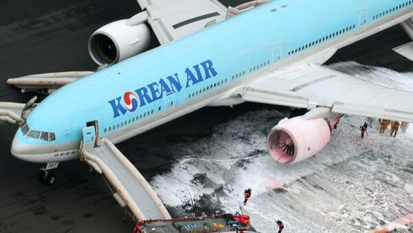 An aerial picture shows fire fighters spraying foam at the engine of a Korean Air Lines plane after smoke rose from it at Haneda airport in Tokyo, Japan, May 27, 2016 - Sputnik International