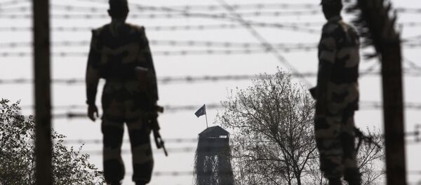 Border Security Force or BSF soldiers patrol an area where a 30-meter (98-foot) long tunnel was found as a Pakistani Rangers outpost is seen in the background at R.S. (File) - Sputnik International