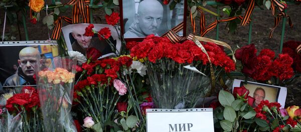 Flowers and candles by Ukrainian embassy in Moscow in memory of journalist Oles Buzina killed in Kiev Flowers and candles by Ukrainian embassy in Moscow in memory of journalist Oles Buzina killed in Kiev - Sputnik International