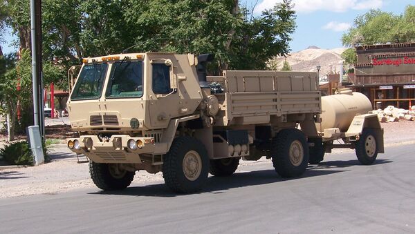 An armored LMTV (Light Medium Tactical Vehicle) pulls a water buffalo through Beatty, Nevada. - Sputnik International