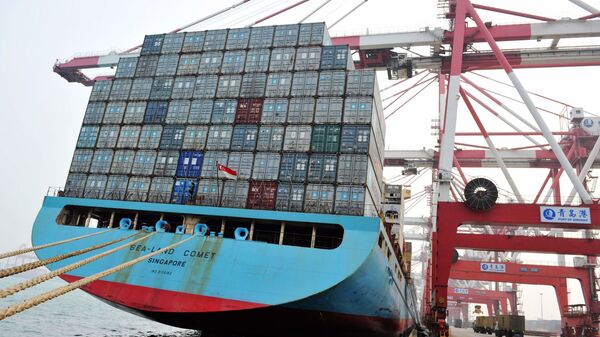 This photo taken on April 12, 2016 shows trucks transporting containers at a port in Qingdao, east China's Shandong province - Sputnik International