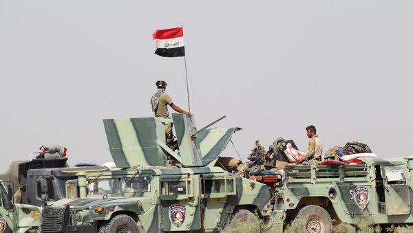 Iraqi security forces sit in military vehicles in the Nuaimiya suburb of Fallujah, Iraq, June 1, 2016 - Sputnik International