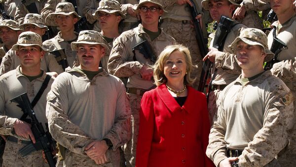 US Secretary of State Hillary Clinton poses for a photograph with members of the USMC FAST Marines, a quick response team from Norfolk, Virginia, on duty at the US Embassy in Cairo, on March 16, 2011 - Sputnik International
