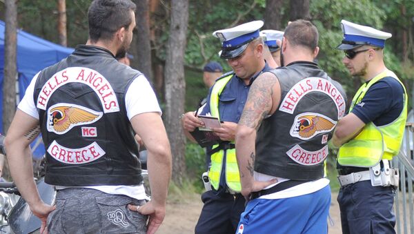 Two Hells Angels bikers are checked by police officers as they wait to enter an enclosed holiday center near Warsaw, Poland, Friday, June 3, 2016 - Sputnik International