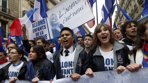 Supporters of French far-right party Front National (FN) shout and hold a banner reading in French the Future is us as they take part in the annual party's rally in honour of Jeanne d'Arc (Joan of Arc) on May 1, 2015 in Paris - Sputnik International