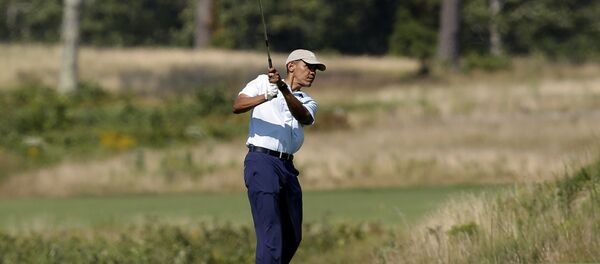 President Barack Obama watches the flight of his ball as he tees off while golfing at Vineyard Golf Club, in Edgartown, Mass President Barack Obama watches the flight of his ball as he tees off while golfing at Vineyard Golf Club, in Edgartown, Mass - Sputnik International