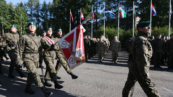 The Honorary Company of the Polish army walks in front of troops that will take part in major international Anakonda-14 defense exercise during the opening ceremony at the National Defense Academy in Warsaw-Rembertow district, Wednesday, Sept. 24, 2014 - Sputnik International