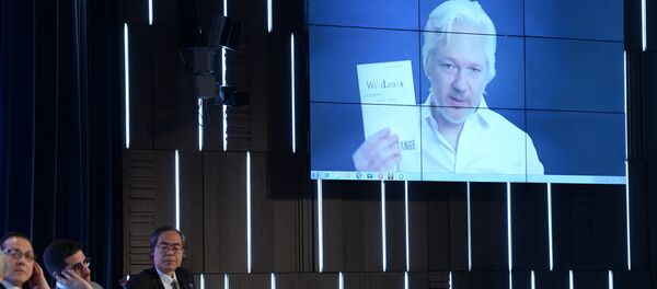 A video link up with Julian Assange, journalist, founder and editor-in-chief of WikiLeaks, at the session, End of the Monopoly: The Open Information Age, held as part of the New Era of Journalism: Farewell to Mainstream international media forum at the Rossiya Segodnya International Multimedia Press Center A video link up with Julian Assange, journalist, founder and editor-in-chief of WikiLeaks, at the session, End of the Monopoly: The Open Information Age, held as part of the New Era of Journalism: Farewell to Mainstream international media forum at the Rossiya Segodnya International Multimedia Press Center - Sputnik International
