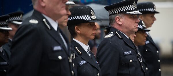 Deputy Commissioner of Britain's Metropolitan Police Craig Mackey (3rd R) leads police officers in a two minute silence outside Scotland Yard in London, on January 8, 2015. Deputy Commissioner of Britain's Metropolitan Police Craig Mackey (3rd R) leads police officers in a two minute silence outside Scotland Yard in London, on January 8, 2015. - Sputnik International