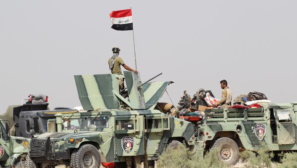 Iraqi security forces sit in military vehicles in suburb of Fallujah, Iraq - Sputnik International