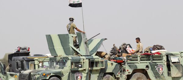 Iraqi security forces sit in military vehicles in suburb of Fallujah, Iraq Iraqi security forces sit in military vehicles in suburb of Fallujah, Iraq - Sputnik International