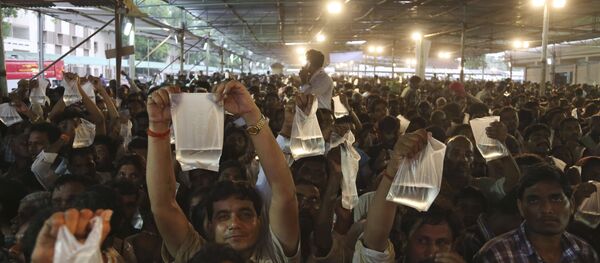 Asthma patients display live fish they are carrying as they wait to receive special fish medicine which they hope will cure them in Hyderabad, India. Asthma patients display live fish they are carrying as they wait to receive special fish medicine which they hope will cure them in Hyderabad, India. - Sputnik International