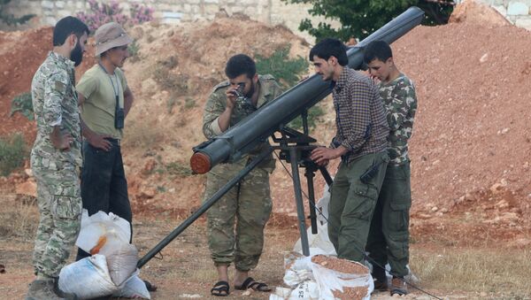 Rebel fighters from the First Regiment, part of the Free Syrian Army, prepare to fire a Grad rocket from Aleppo's Al-Haidariya neighbourhood, towards forces loyal to Syria's President Bashar al-Assad stationed in Talet al-Sheikh Youssef, Syria May 29, 2016 - Sputnik International