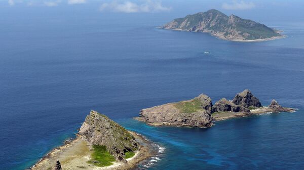A group of disputed islands, Uotsuri island (top), Minamikojima (bottom) and Kitakojima, known as Senkaku in Japan and Diaoyu in China is seen in the East China Sea (File)  - Sputnik International