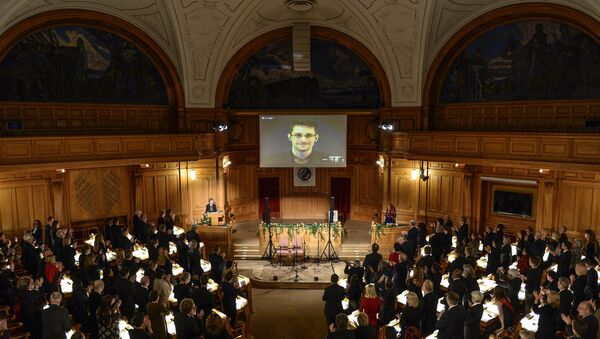 Fugitive US intelligence leaker Edward Snowden is shown on a livestream from Moscow during the Right Livelihood Award ceremony at the Swedish Parliament, in Stockholm, on December 1, 2014 - Sputnik International