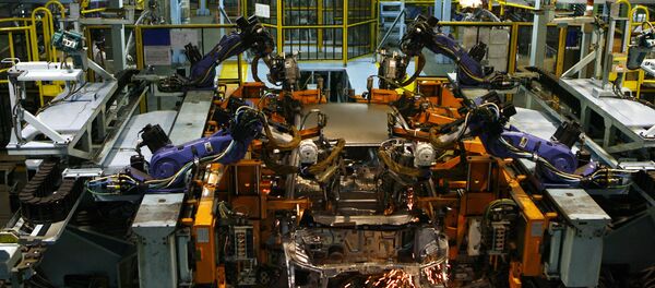 Sparks fly from a robot as it performs spot welding on a car on the production line at Honda Siel Cars India Ltd. (HSCI) factory in Noida, a satelite town on the outskirts of New Delhi on February 25, 2008 Sparks fly from a robot as it performs spot welding on a car on the production line at Honda Siel Cars India Ltd. (HSCI) factory in Noida, a satelite town on the outskirts of New Delhi on February 25, 2008 - Sputnik International
