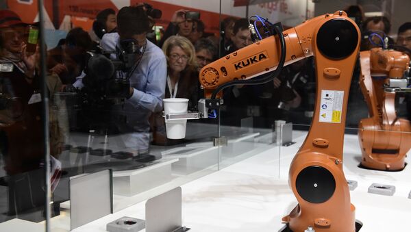 A robot prepares a cup of coffee at the booth of robotics manufacturer KUKA on the eve of the opening of the Hannover Messe (Hanover fair) in Hanover, northern Germany, on April 23, 2016 - Sputnik International