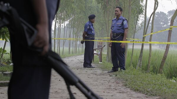 In this Oct. 4, 2015 file photo, Bangladeshi security officers stand by the site where Japanese citizen Kunio Hoshi was killed at Mahiganj village in Rangpur district, 300 kilometers (185 miles) north of Dhaka, Bangladesh - Sputnik International