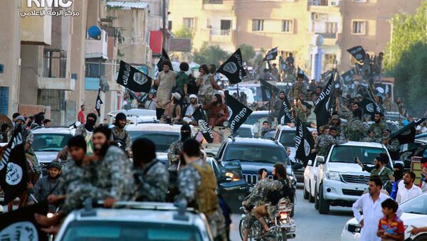 In this undated file image posted on Monday, June 30, 2014, by the Raqqa Media Center of the Islamic State group, a Syrian opposition group, which has been verified and is consistent with other AP reporting, fighters from the Islamic State group parade in Raqqa, north Syria - Sputnik International