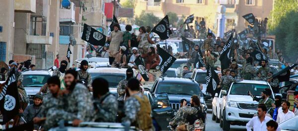 In this undated file image posted on Monday, June 30, 2014, by the Raqqa Media Center of the Islamic State group, a Syrian opposition group, which has been verified and is consistent with other AP reporting, fighters from Daesh group parade in Raqqa, north Syria - Sputnik International
